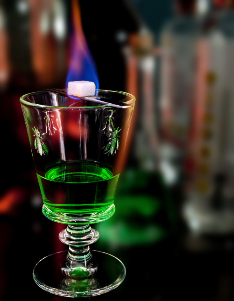 absinthe with ice cube on fire
